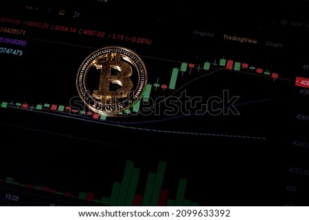 Coin Bitcoin on background cryptocurrency trading chart on computer screen. Digital money, banking, investment, finance and business concept