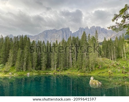 Lake Carezza, Italy. Lago di Carezza lake or The Karersee with reflection of mountains in the dolomite alps, Dolomites, Tyrol, Italy. Concept of ideal resting place. Popular travel destination.