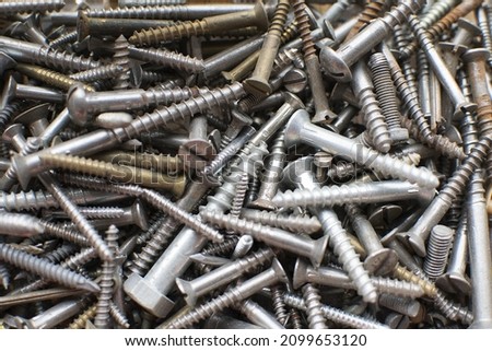 tapping screws made od steel, metal screw, iron screw, chrome screw, screws as a background, wood screw,  Royalty-Free Stock Photo #2099653120