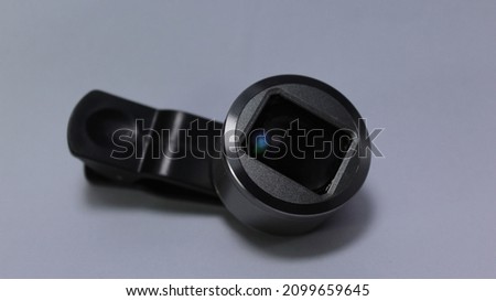 Mobile phone with zoom lens,clip and cover isolated on background. Gold smart phone with lens isolated, lens wide for cell phone camera and clip, macro lens isolated.