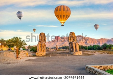 Hot air balloons over Colossi of Memnon in Luxor, Egypt Royalty-Free Stock Photo #2099691466