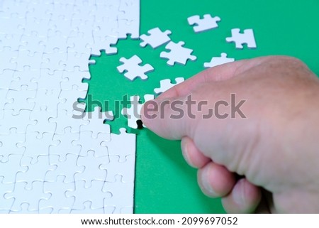 Business solutions, success and strategy concept, the last piece of the puzzle hand put solves realizes the project