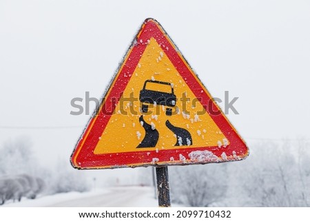 road sign red triangle with a yellow field with a picture of a car and a winding road