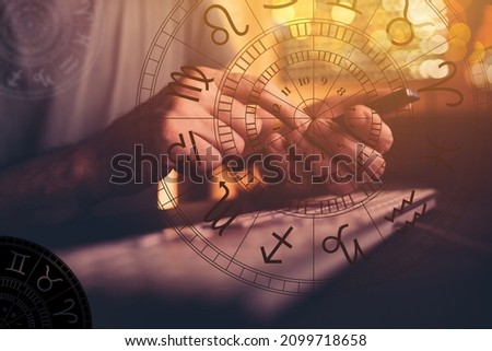 Astrologer using mobile smart phone app and computer to make predictions on future outcome, selective focus