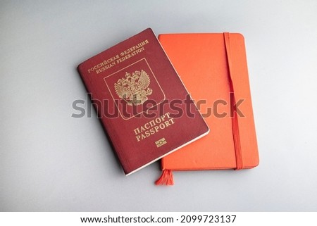 Russian pasport and red notebook on grey Royalty-Free Stock Photo #2099723137