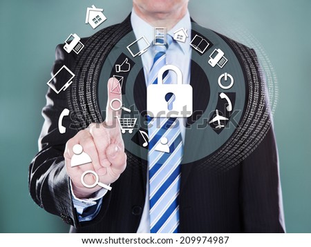 Midsection of businessman pressing virtual icons over colored background
