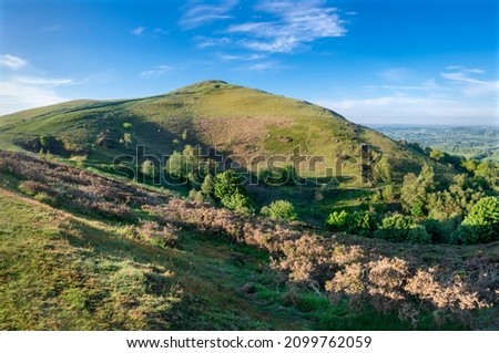 Soon after sunrise in the summer,looking southwards at the second main hill from the north of the Malvern hill range.Sugarloaf Hill lies between the Worcestershire Beacon and North Hill. Royalty-Free Stock Photo #2099762059