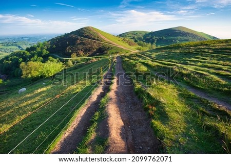 Soon after sunrise in the summer,looking northwards at the second main hill from the north of the Malvern hill range.Sugarloaf Hill lies between the Worcestershire Beacon and North Hill. Royalty-Free Stock Photo #2099762071