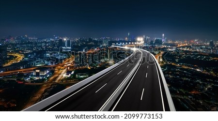 Top view and curvy of Highway overpass with beautiful city background. night scene. Royalty-Free Stock Photo #2099773153