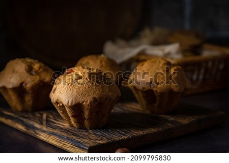 Muffins on wooden plate. Still life photo. 