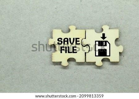 wooden puzzle with save file icon and word save file