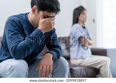 Asian man are disappointed and saddened after an argument with wife. Asian couples are having family problems resulting in divorce. Lover broken and Love problem Royalty-Free Stock Photo #2099818897
