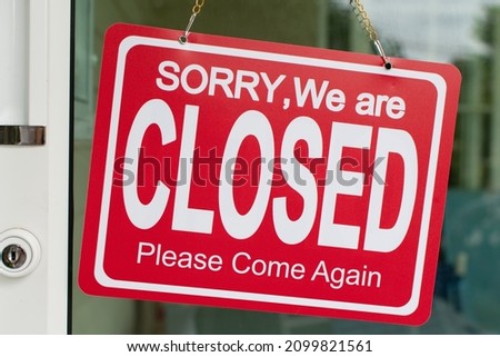 Red sorry we are closed sign hang on the door