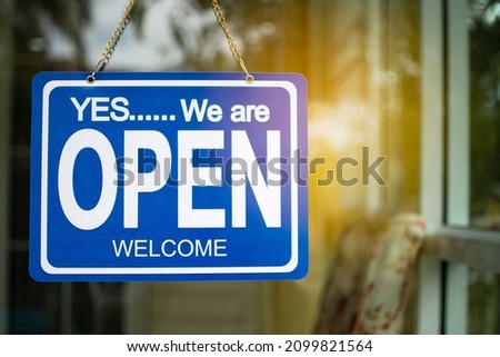 Blue yes we are open sign hang on the door