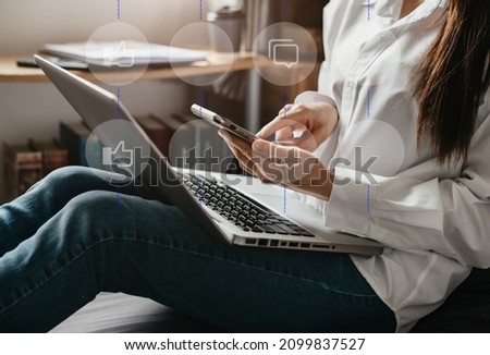 Woman hand using smart phone, mobile payments online shopping,omni docking keyboard computer with virtual interface icons screen.