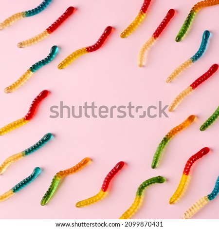 Gummy candies pattern on bright pink background with copy space. Minimal food concept with flat lay view.