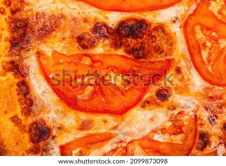 Pizza with tomatoes as a background. Close-up