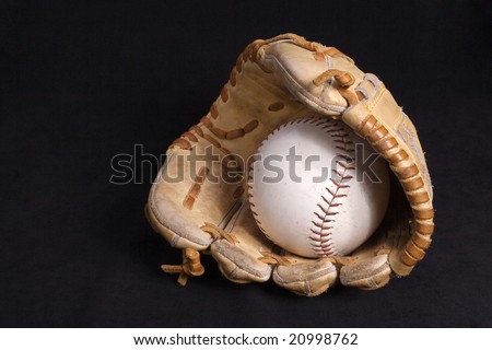 Softball glove in black background