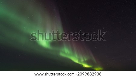 Northen lights with green colour sky Royalty-Free Stock Photo #2099882938