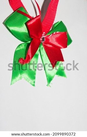 Portrait photo of red and green Christmas satin ribbon decorations. Negative space or area for text