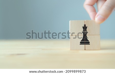 Success business strategy concept. Change and strategy management for business adaptation. Hand put the wooden cubes with chess icon on beautiful grey background and copy space. Game changing concept.