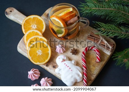 Fruit tea, oranges and various sweets on the New Year's table.