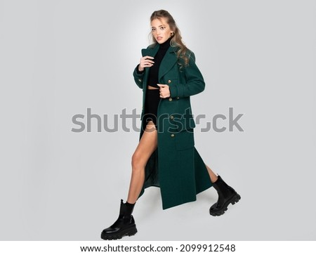 Vogue female coat. Fashion model. Elegant woman wearing fashion dress in studio. Beautiful girl wear fashion clothes casual dress, vogue style, full length. Royalty-Free Stock Photo #2099912548