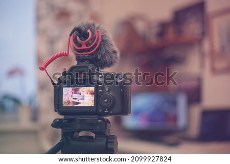 Digital camera with a microphone windshield in the room. Blogging equipment. Soft focus retro colors