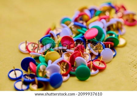 Colorful thumbtacks close up macro shot, shallow depth of field, image for background. Royalty-Free Stock Photo #2099937610