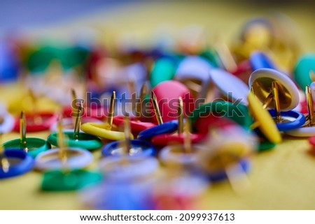 Colorful thumbtacks close up macro shot, shallow depth of field, image for background. Royalty-Free Stock Photo #2099937613