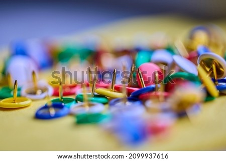 Colorful thumbtacks close up macro shot, shallow depth of field, image for background. Royalty-Free Stock Photo #2099937616