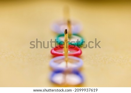 Colorful thumbtacks close up macro shot, shallow depth of field, image for background. Royalty-Free Stock Photo #2099937619