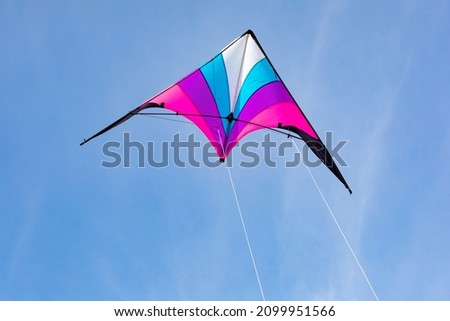 Colorful kite flying in the blue sky 