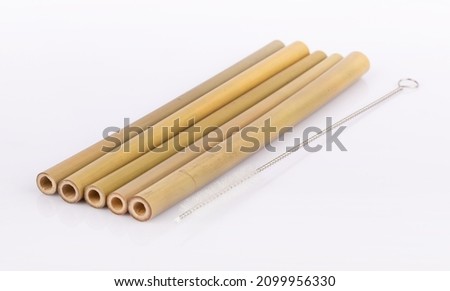 Bamboo straws on a white background. Ecological bamboo straws. Thanks to these bamboo straws, we can be a more environmentally conscious society. Say no to plastic. Royalty-Free Stock Photo #2099956330
