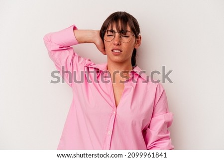 Young Argentinian woman isolated on white background tired and very sleepy keeping hand on head.