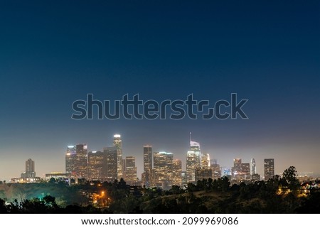 Illuminated Skyline of Los Angeles downtown at summer night time, California, USA. Skyscrapers of panoramic city center of LA.
