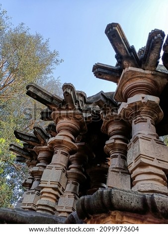 Stock photo of exterior view of ancient Kopeshawar Mahadev temple pillar, beautiful stone carving and pillar structure revealed Hindu culture and traditions. Picture captured under bright sunlight.