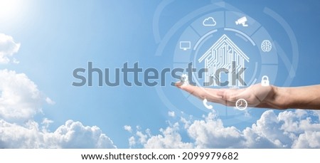 Businessman hold house icon.Smart home controlled, intelligent house, and home automation app concept.Pcb design and person with smart phone. Innovation technology internet Network Concept Royalty-Free Stock Photo #2099979682