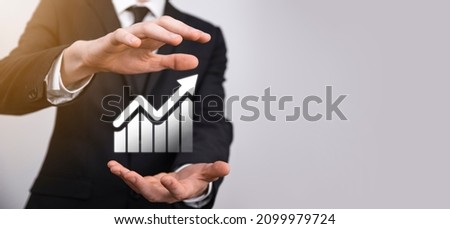 Male hand holding graph icon symbol.checking analyzing sales data growth graph chart and stock market on global networking. Business strategy, planning and digital marketing.