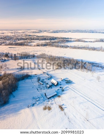 snow and frost in the field from drone, snowy field and frozen river
