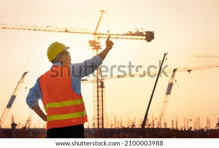 Surveyor Large building Engineer technician  Business Team discuss plan at new construction site. . High ground heavy industry and safety concept.