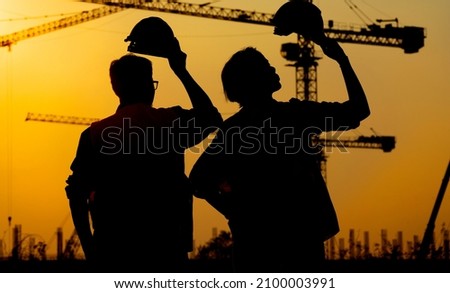 Surveyor Large building Engineer technician  Business Team discuss plan at new construction site. Road construction machinery on the construction of highway. Ground heavy industry and safety concept.