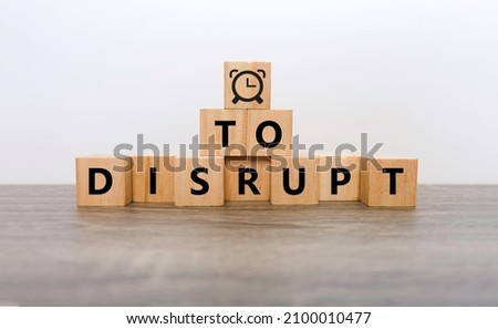 Woodblocks cubes with "Disrupt" text and Clock symbol, time to Disrupt concept