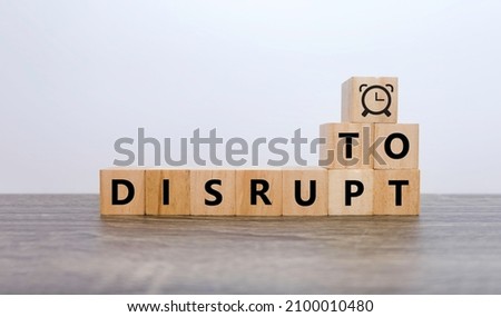 Woodblocks cubes with "Disrupt" text and Clock symbol, time to Disrupt concept