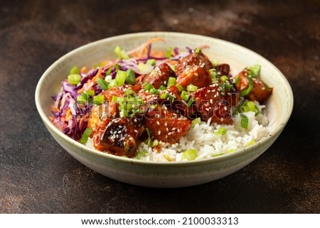 Vegan fried tempeh with rice and vegetables. Asian healthy food Royalty-Free Stock Photo #2100033313