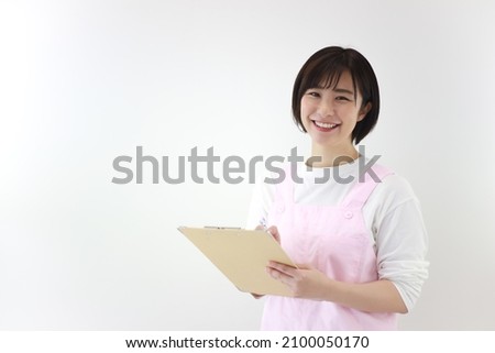 Image of a nursery teacher with a binder  Royalty-Free Stock Photo #2100050170