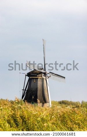 Vertical picture of one of the famous Dutch windmills at Kinderdijk, a UNESCO world heritage site. On the photo is one mill of the 19 windmills at Kinderdijk, South Holland, the Netherlands, which are