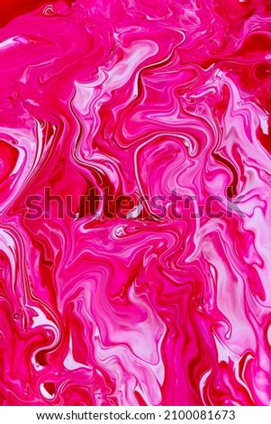 Attractive abstract background: spilled red and caramel pink nail polish, marbled blend effect