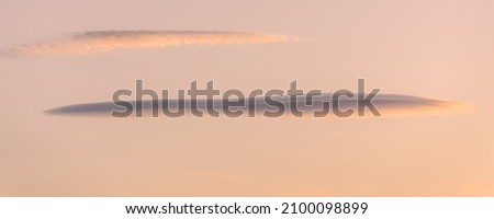 Lenticular cloud in the sky at sunset. Banner, panoramic, (altocumulus lenticularis). France.