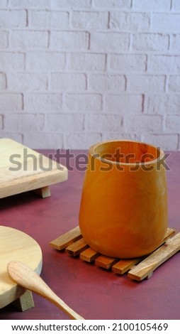Wooden cup on a red table with a neat arrangement so that it gives an elegant and exclusive impression. food and drink concept.
